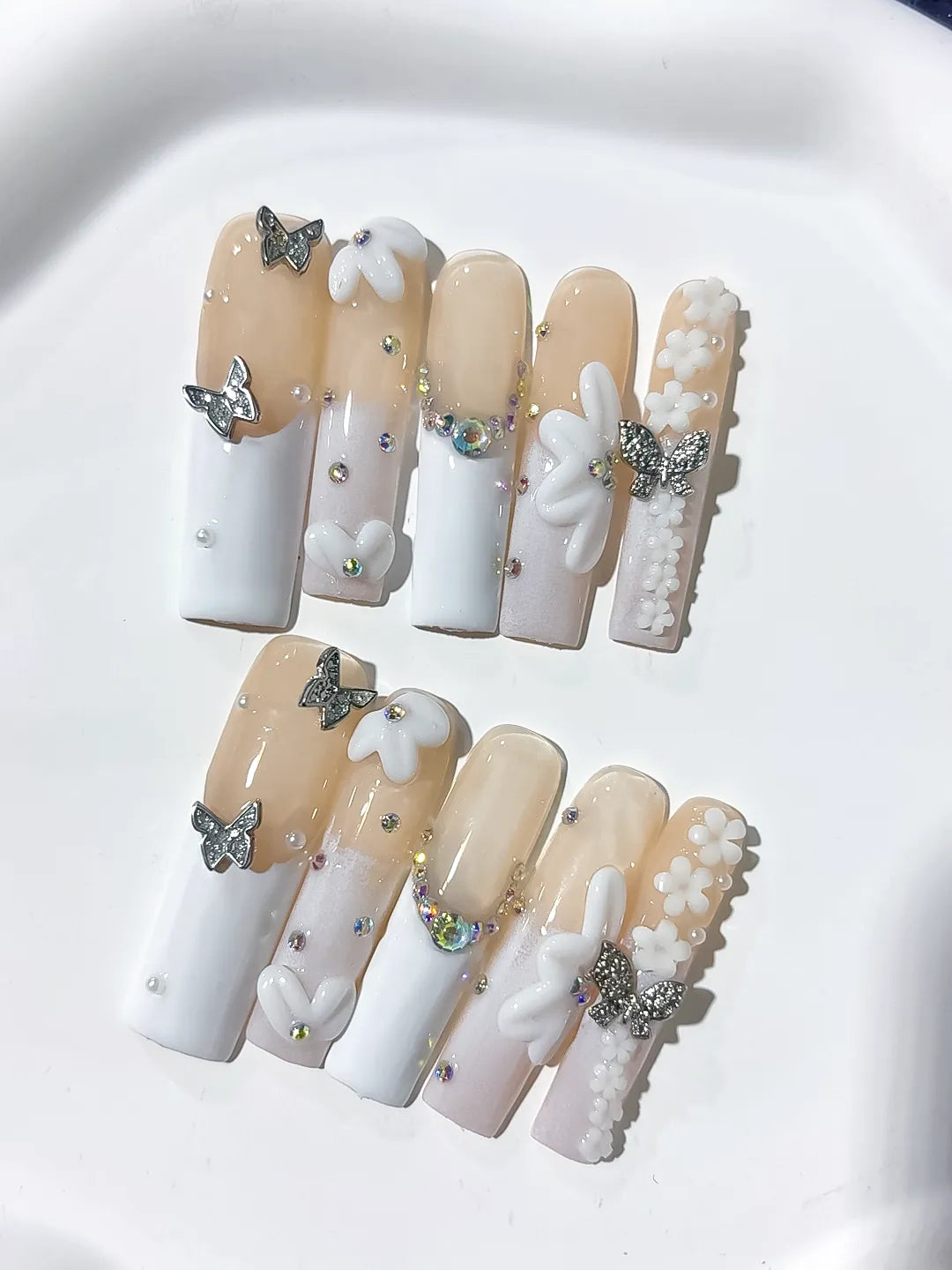Nude White Silver Gold French tip Bow Pearl Rhinestone press on nails close up