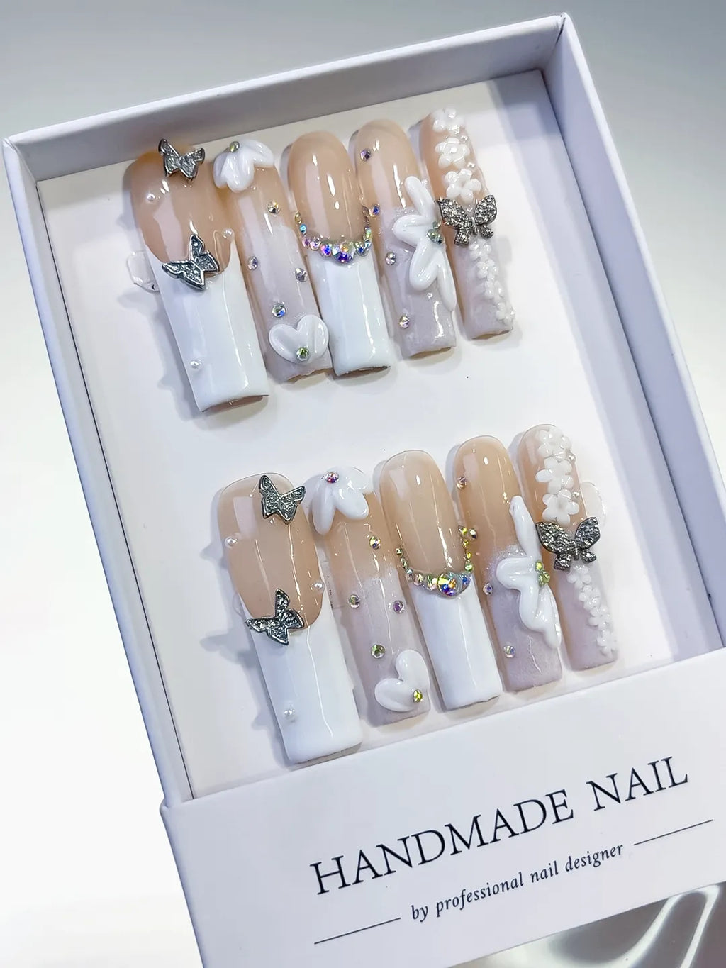 Nude White Silver Gold French tip Bow Pearl Rhinestone press on nails angled view
