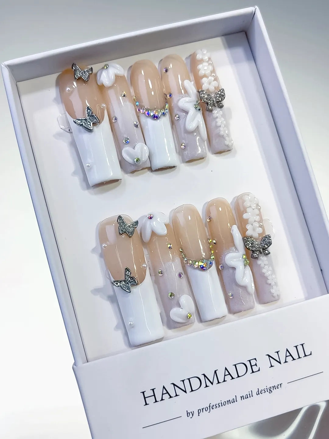 Nude White Silver Gold French tip Bow Pearl Rhinestone press on nails angled view