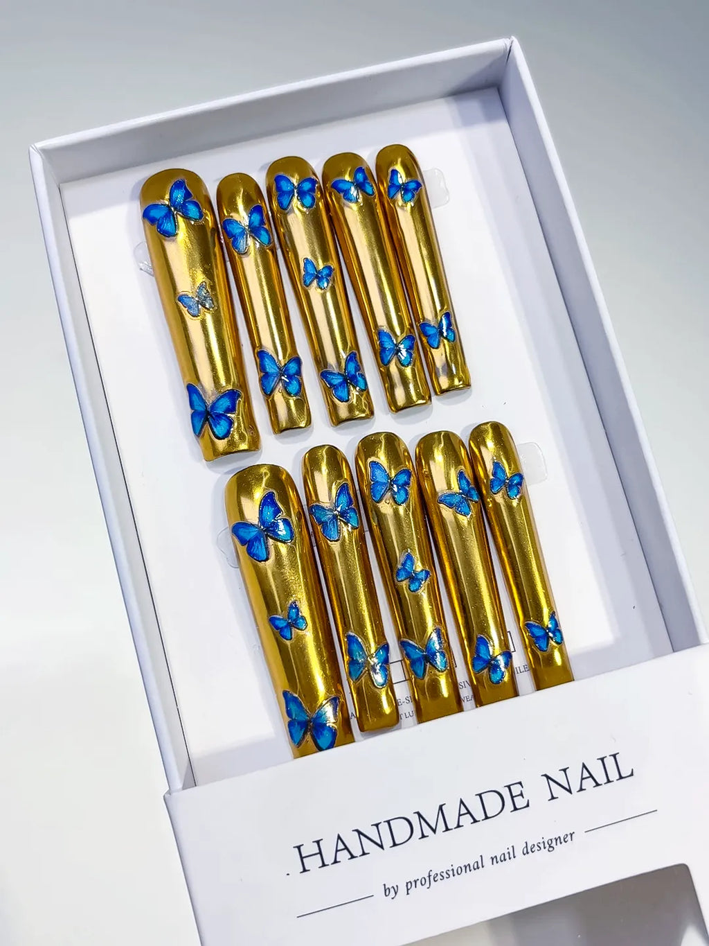 Gold Blue Metallic Butterfly press on nails angled view