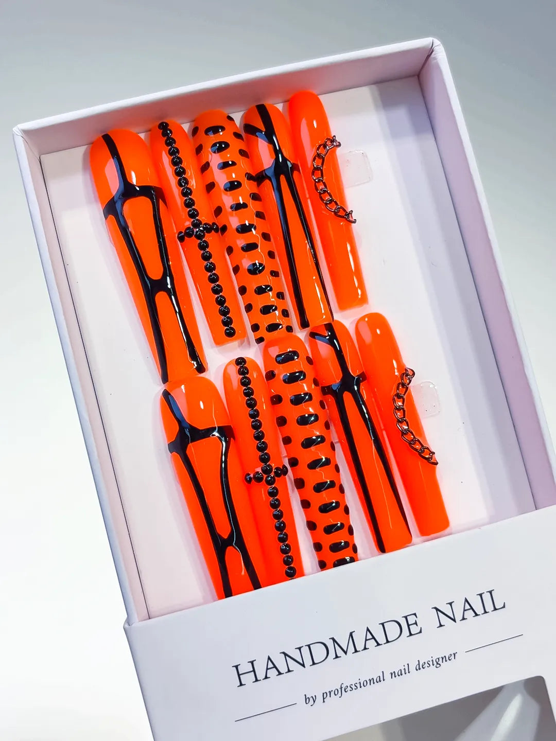 Orange Black Silver Abstract Chain Stud press on nails angled view