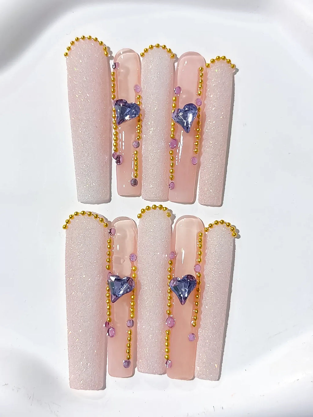 Nude White Gold Purple Glitter Heart Rhinestone Pearl press on nails close up