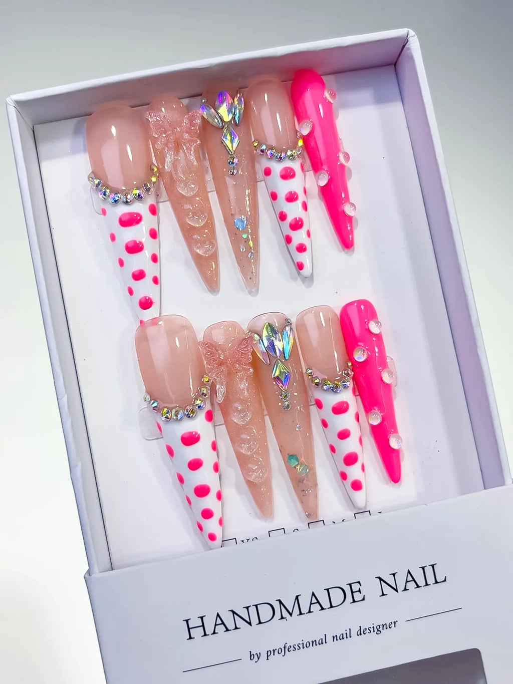 Nude White Pink Silver Abstract Dot Pattern Bow Rhinestone 3D press on nails angled view