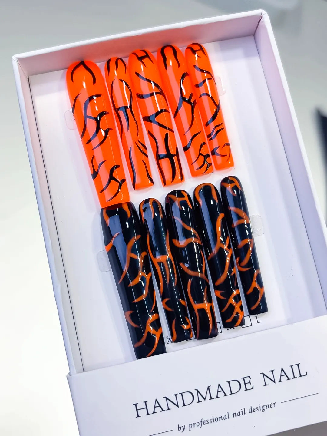Orange Black Abstract press on nails angled view