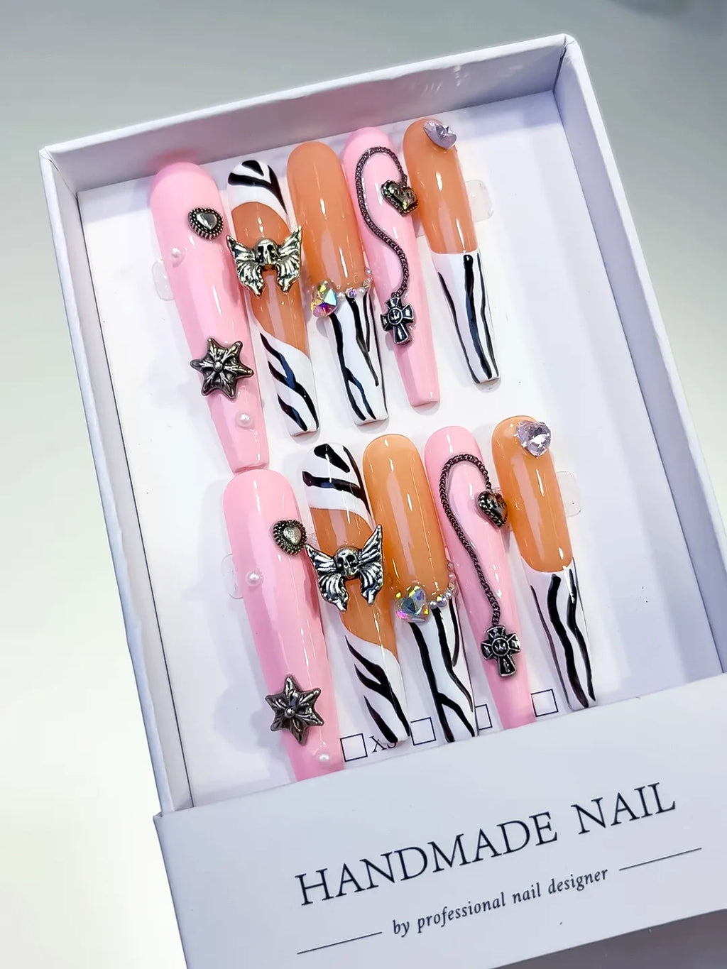 Pink Nude White Black Silver Abstract Star Bow Cross Heart Metallic Charm press on nails angled view