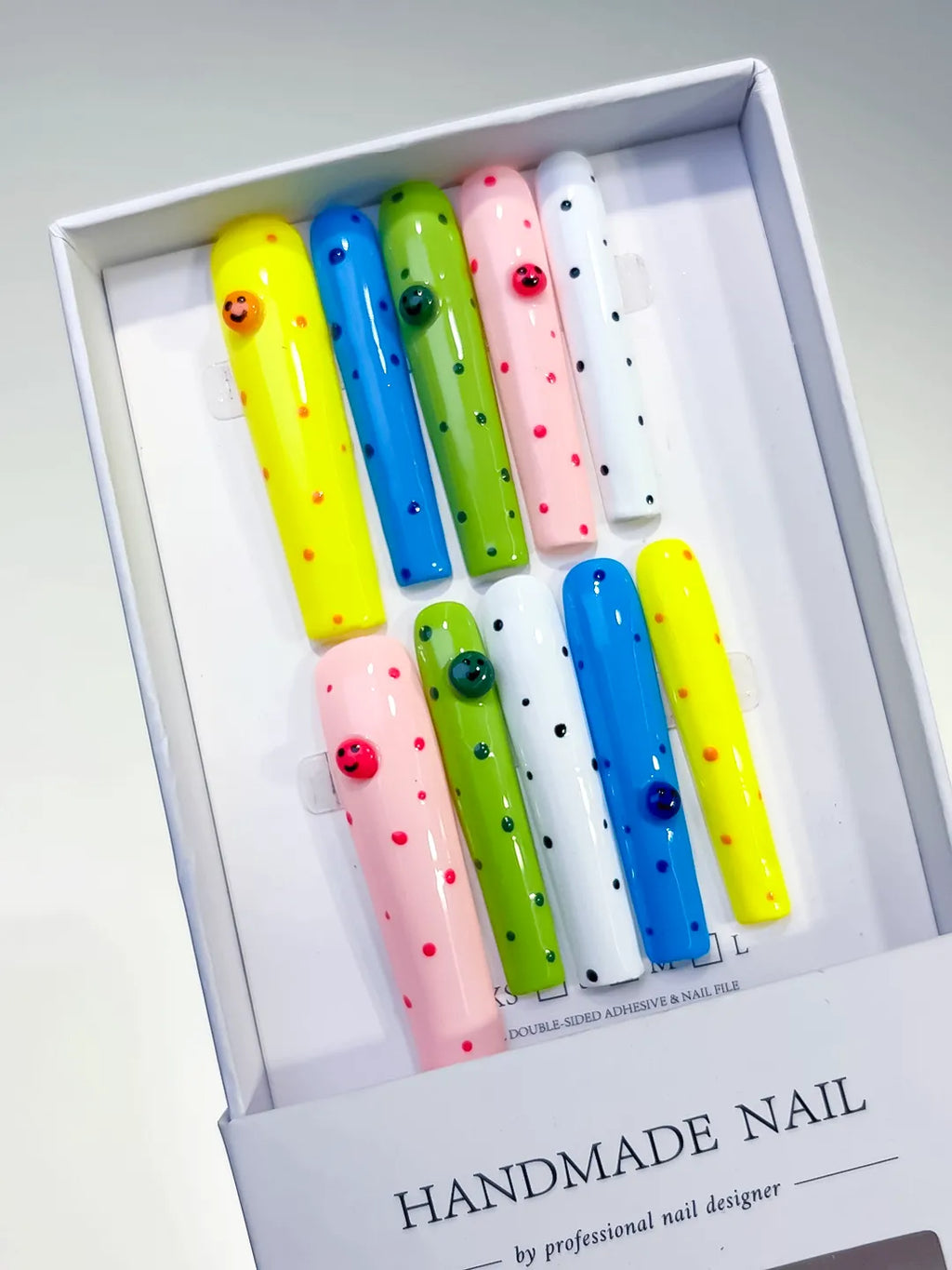 Yellow Blue Green Pink White Black Solid color Dot Pattern Smiley Rhinestone press on nails angled view