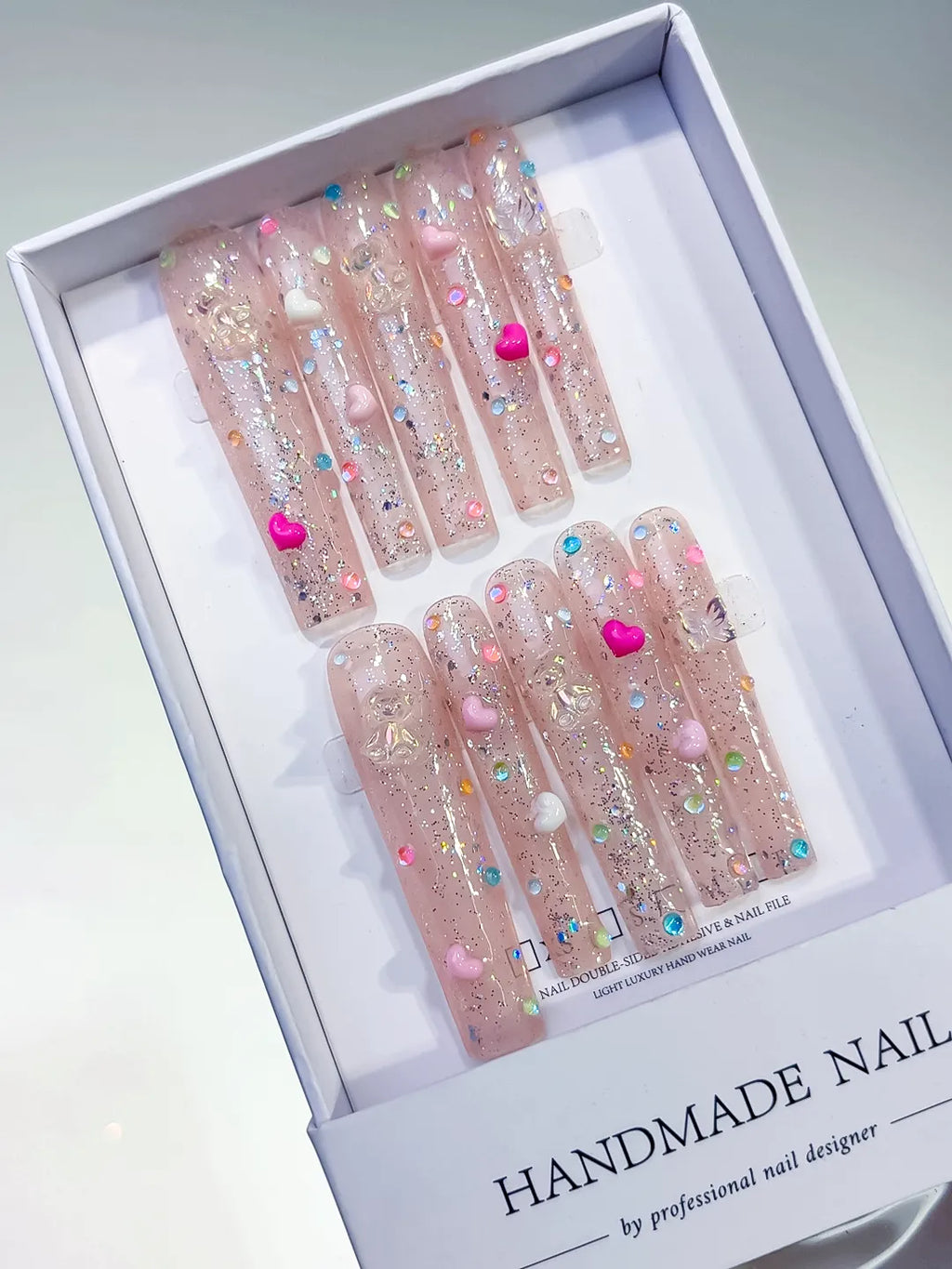 Nude Pink Silver Glitter Heart Pearl 3D press on nails angled view