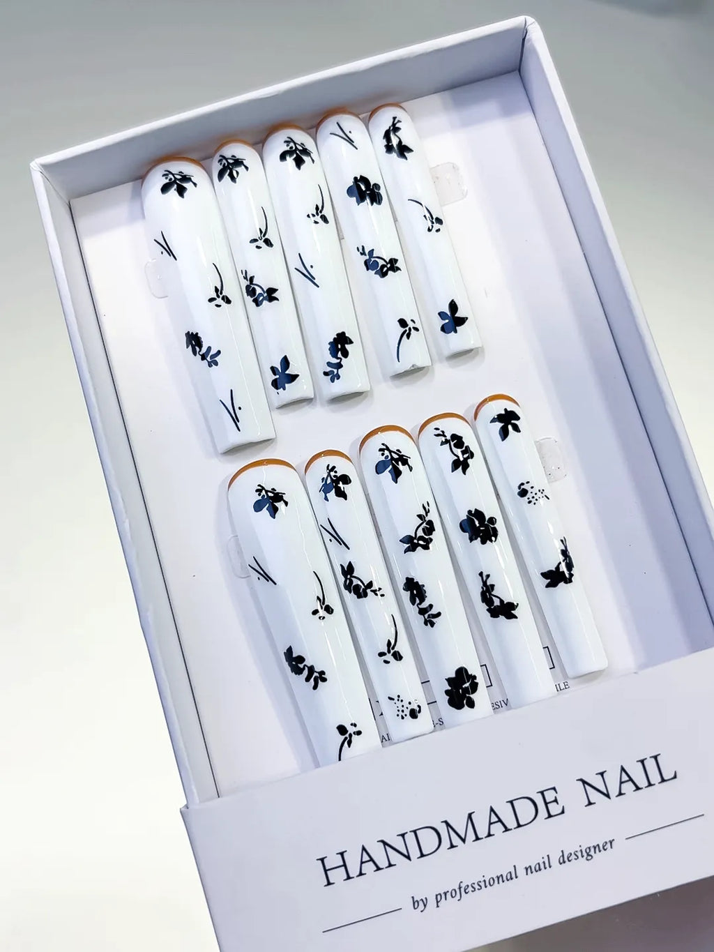White Black Gold Floral press on nails angled view