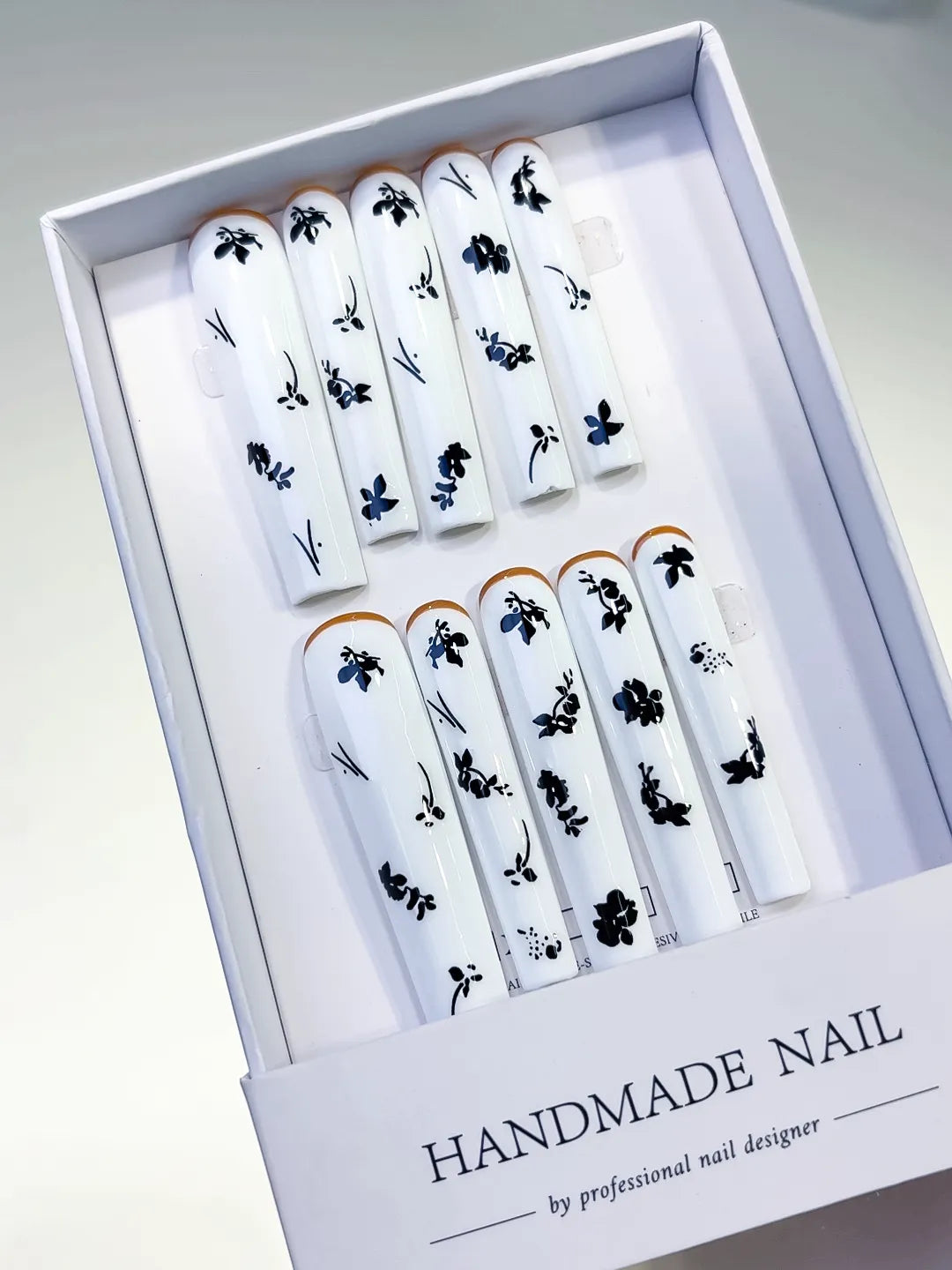White Black Gold Floral press on nails angled view