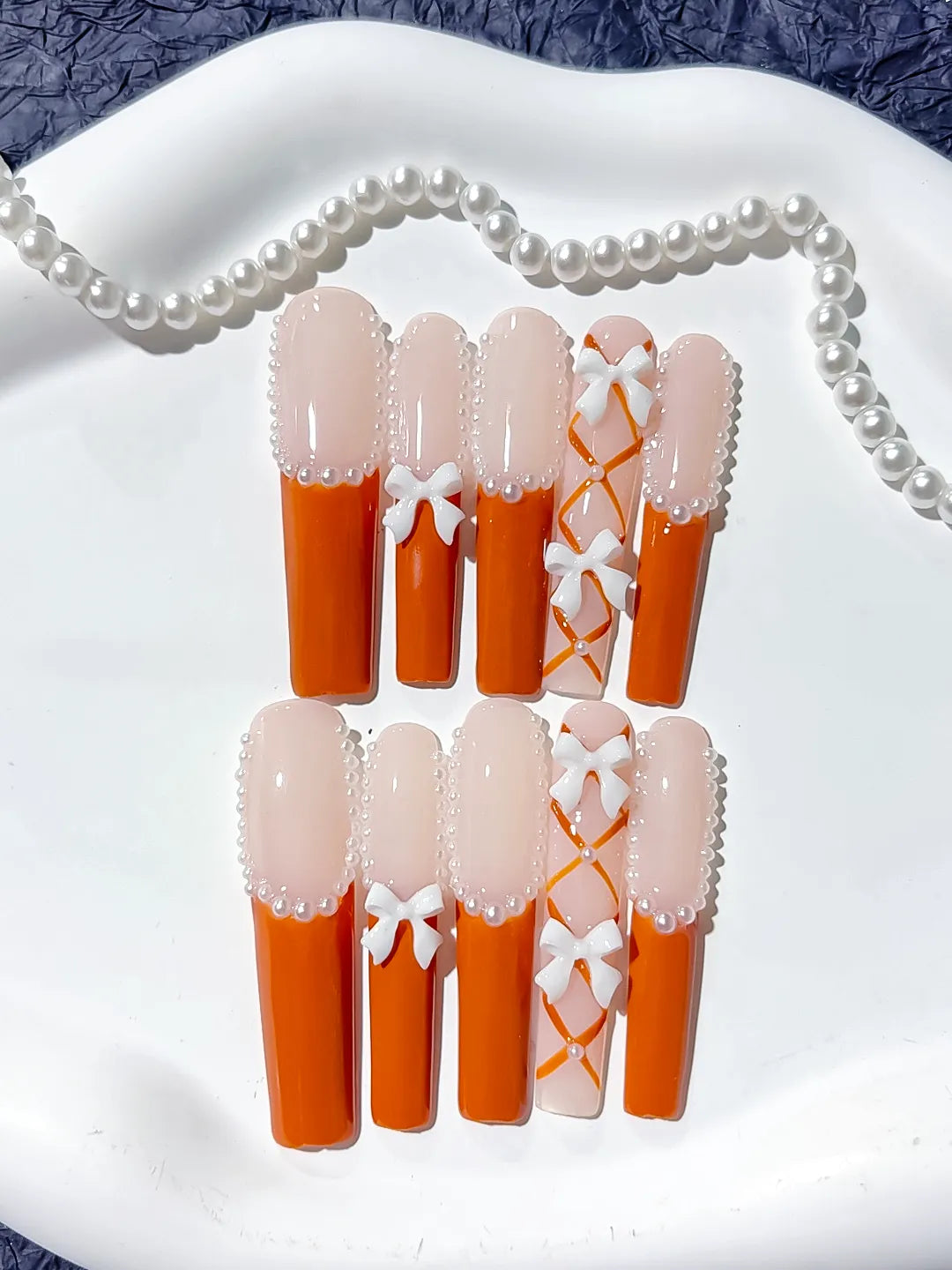 Nude Orange White Silver French tip Bow Pearl 3D press on nails close up