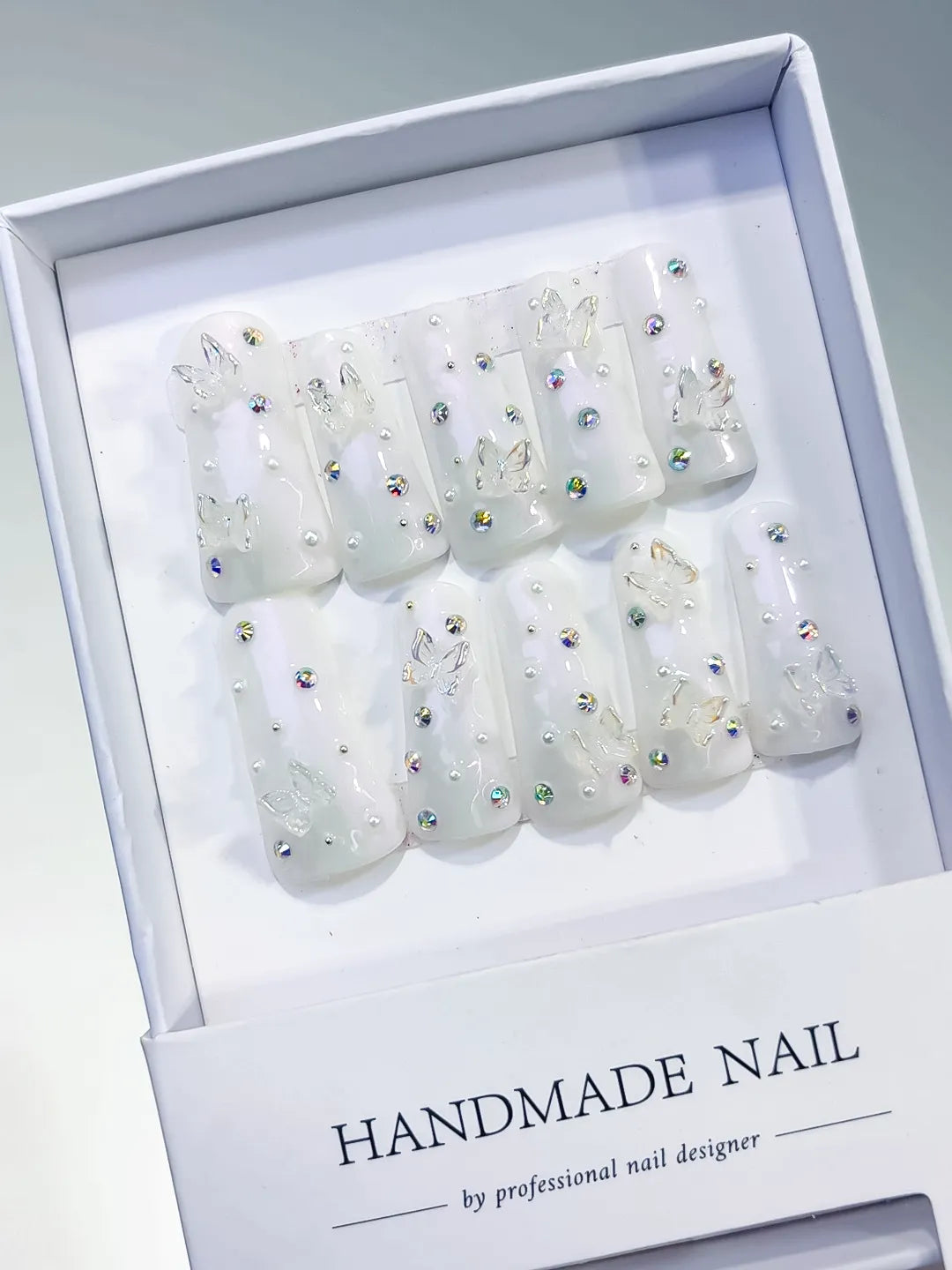 White Silver Multicolor Solid color Butterfly Pearl Rhinestone 3D press on nails angled view