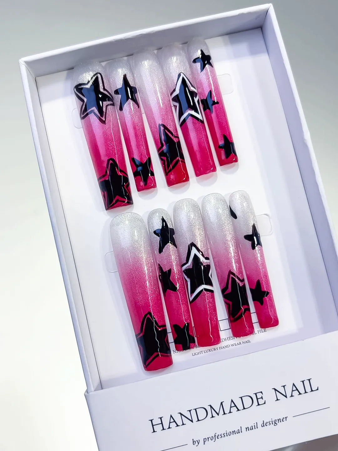 White Pink Black Ombre Star 3D press on nails angled view