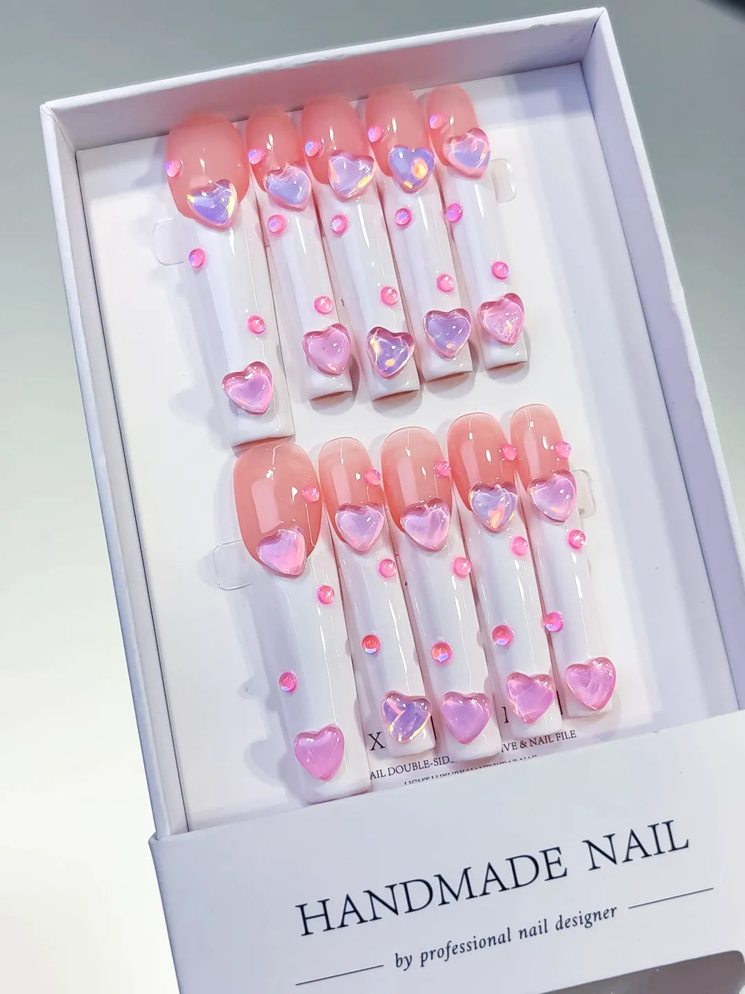 Pink White Multicolor French tip Heart 3D press on nails angled view