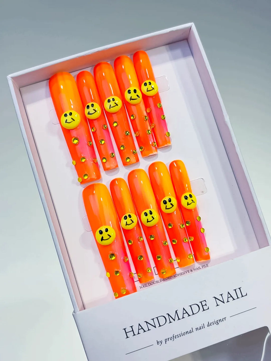 Orange Pink Yellow Ombre Smiley Rhinestone 3D press on nails angled view