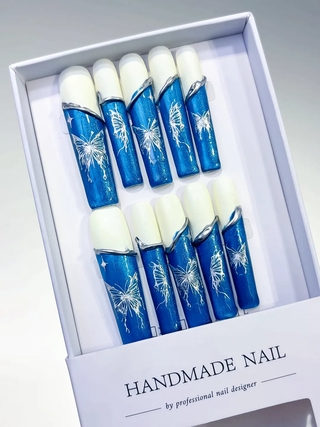 Blue White Silver French tip Floral press on nails angled view