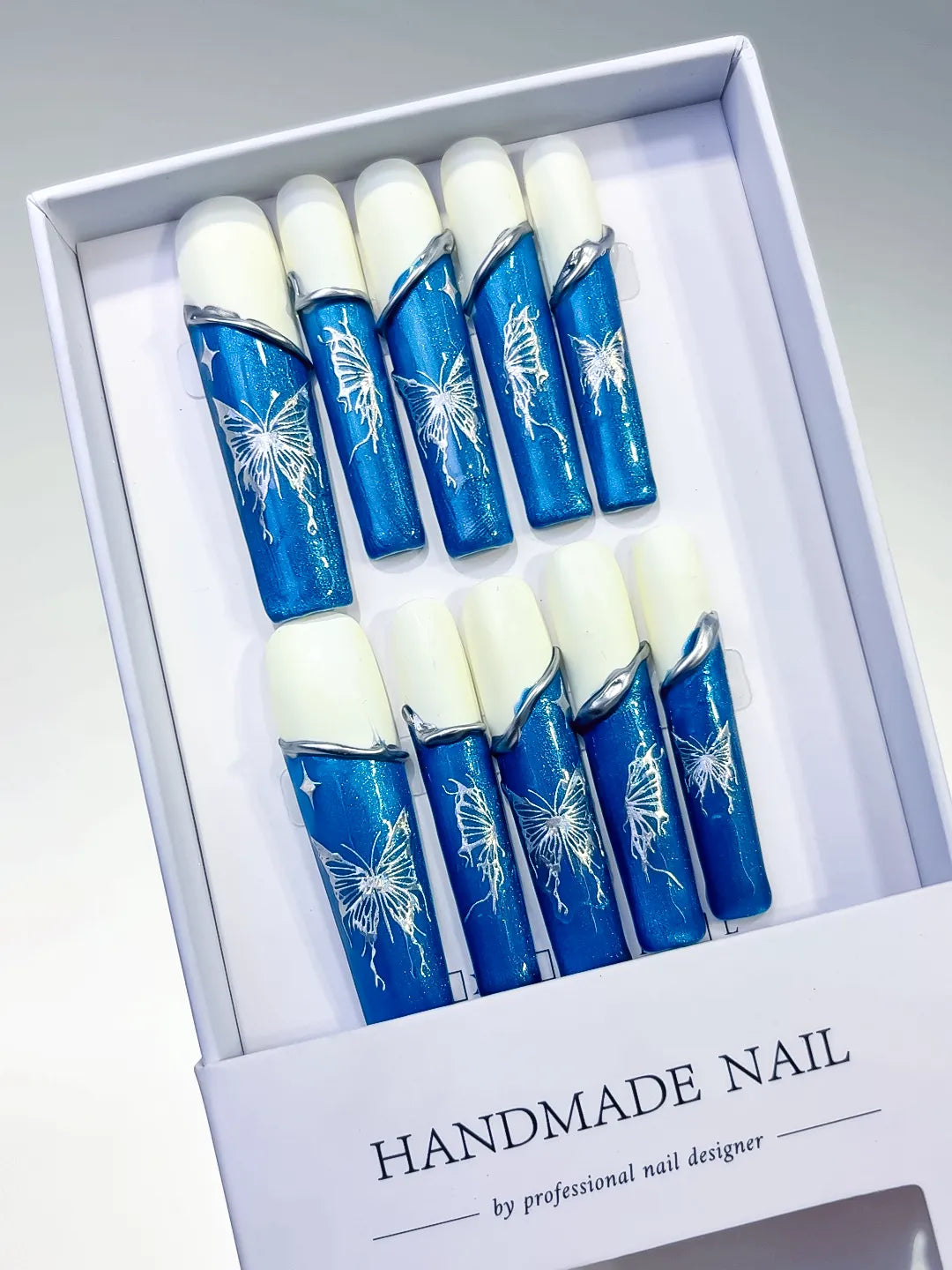 Blue White Silver French tip Floral press on nails angled view