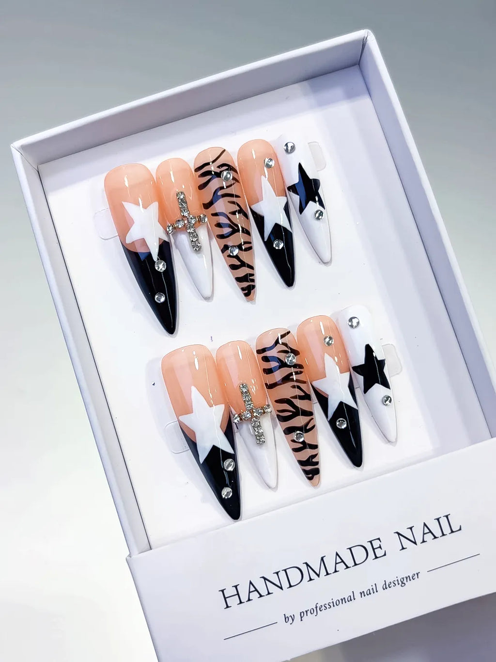 Nude White Black Abstract Star Animal Print Bow Rhinestone press on nails angled view