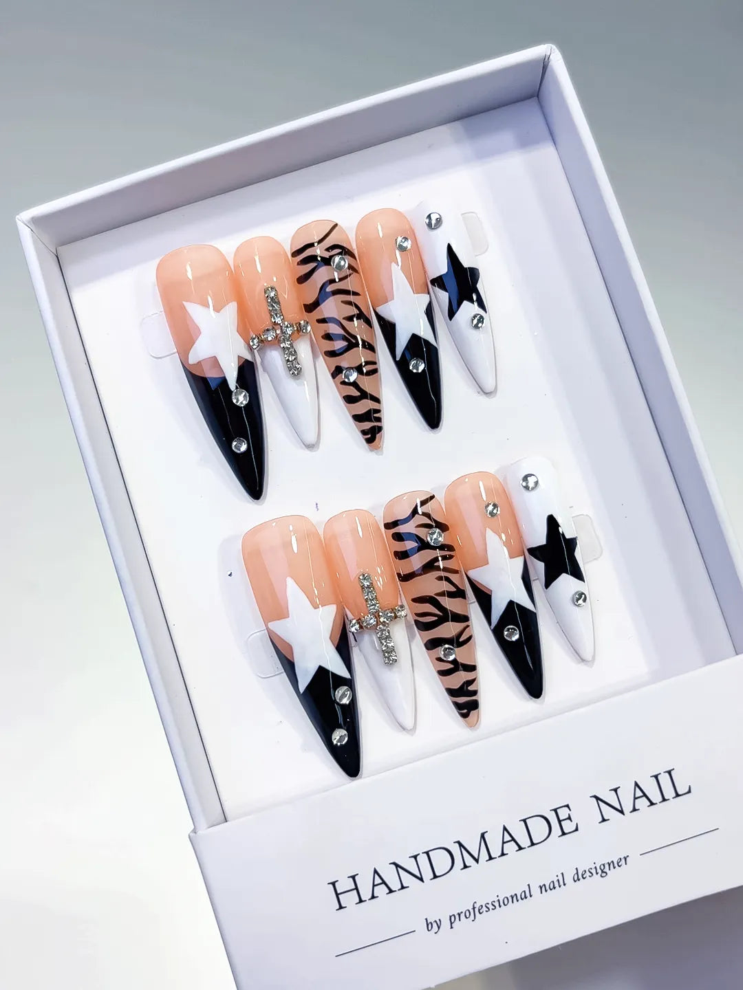 Nude White Black Abstract Star Animal Print Bow Rhinestone press on nails angled view