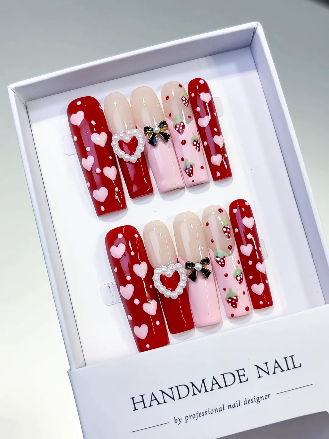 Red Pink Nude White Black Abstract Heart Bow Strawberry Pearl 3D press on nails angled view