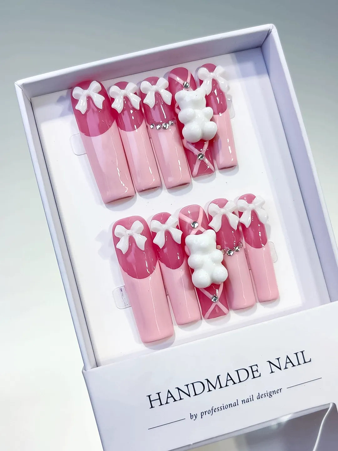 Pink White Solid color Bow Bear Rhinestone 3D press on nails angled view