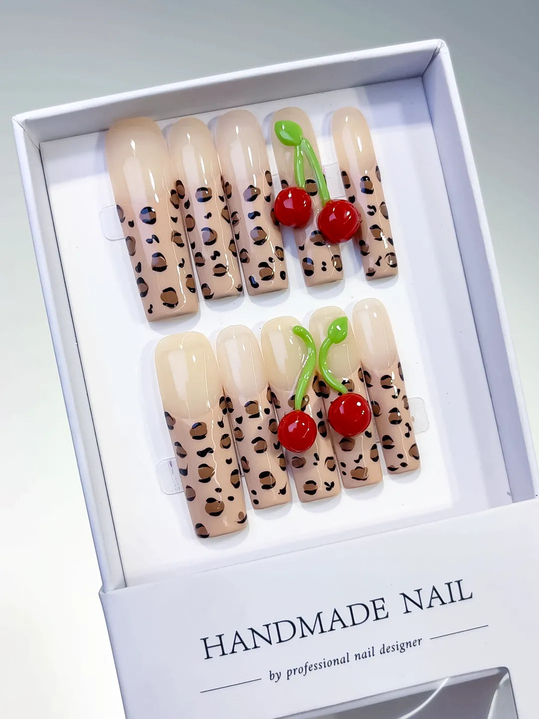 Nude Brown Black Red Green Abstract Animal Print Cherry 3D press on nails angled view