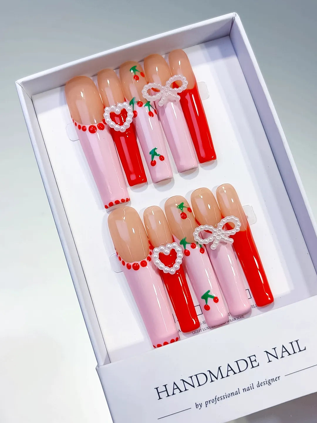 Nude Pink Red White Silver Abstract Cherry Heart Bow Pearl 3D press on nails angled view