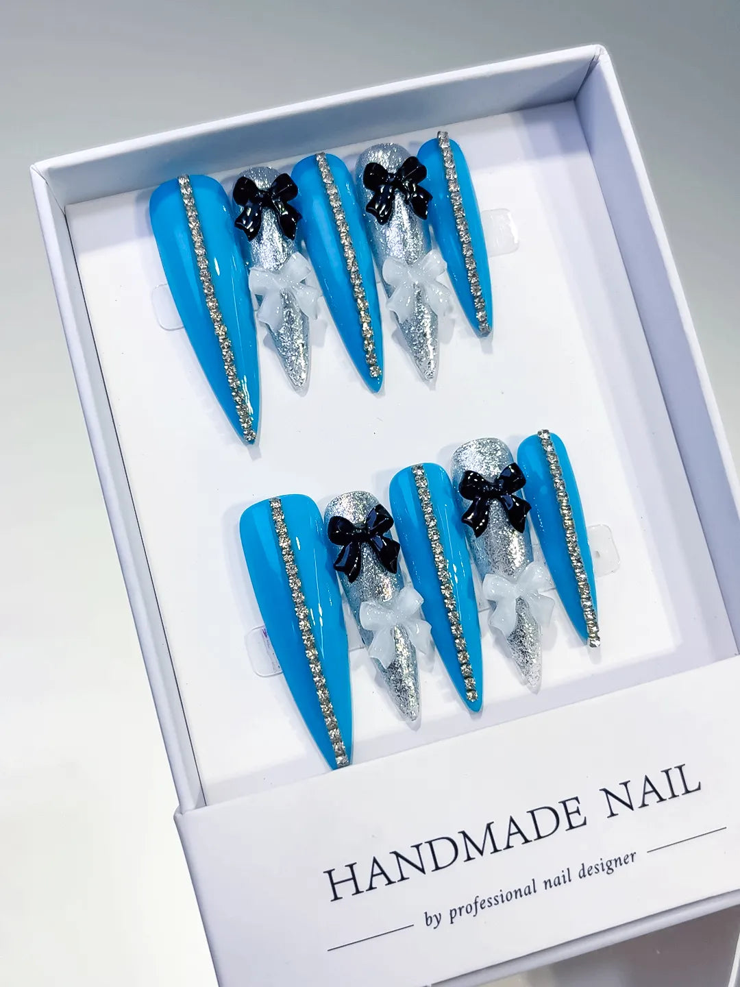 Blue Silver White Black Abstract Bow Glitter 3D press on nails angled view