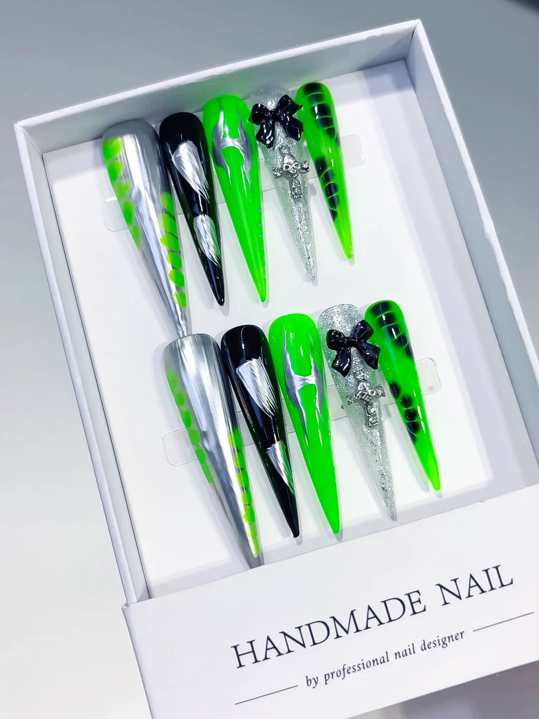 Silver Black Green Abstract Bow Cross Glitter press on nails angled view