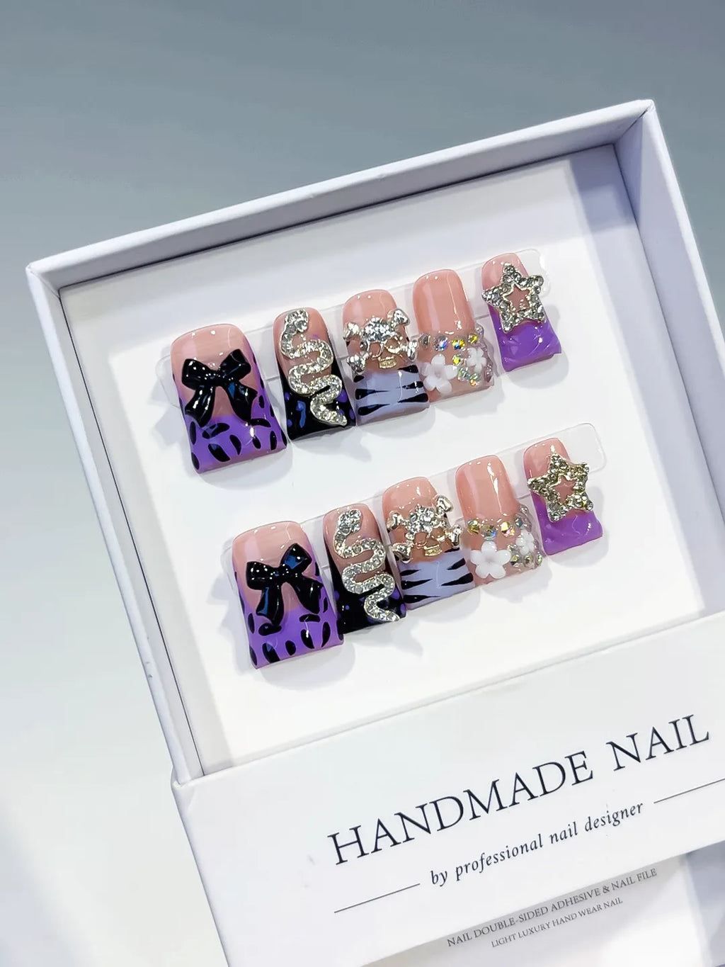Nude Purple Black White Silver Abstract Bow Snake Star Flower Rhinestone press on nails angled view