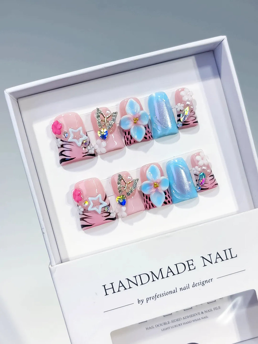 Pink Blue Black White Silver Abstract Flower Butterfly Star Rhinestone 3D press on nails angled view