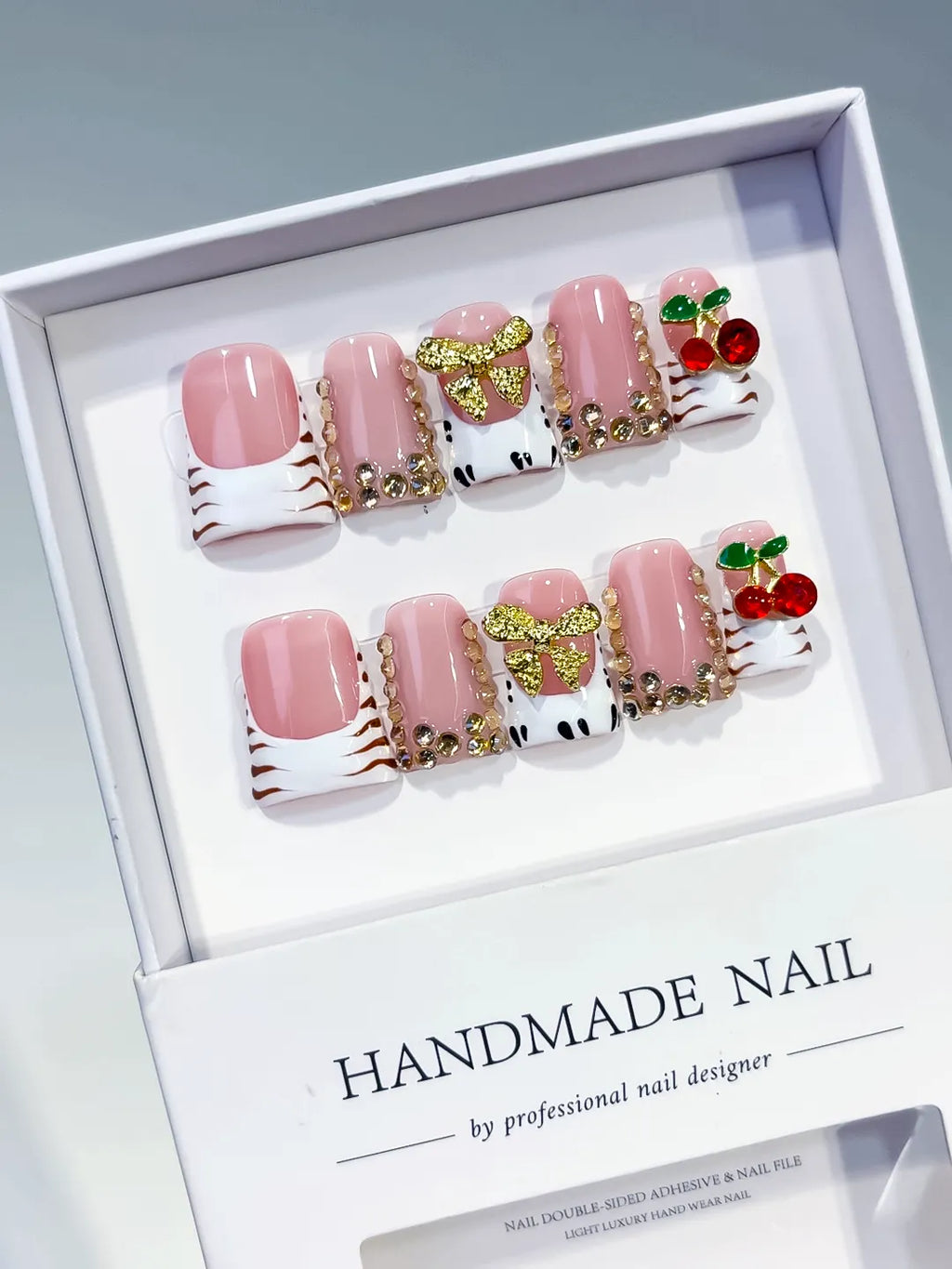 Pink White Gold Red French tip Bow Cherry Rhinestone 3D press on nails angled view