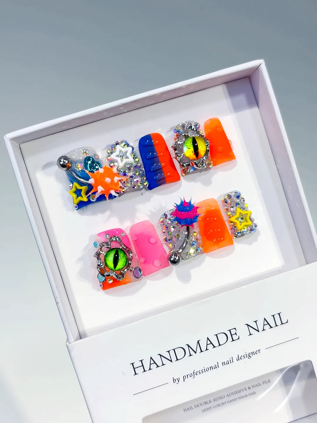Blue Orange Pink Silver Black Yellow Abstract Star Eye Rhinestone 3D press on nails angled view