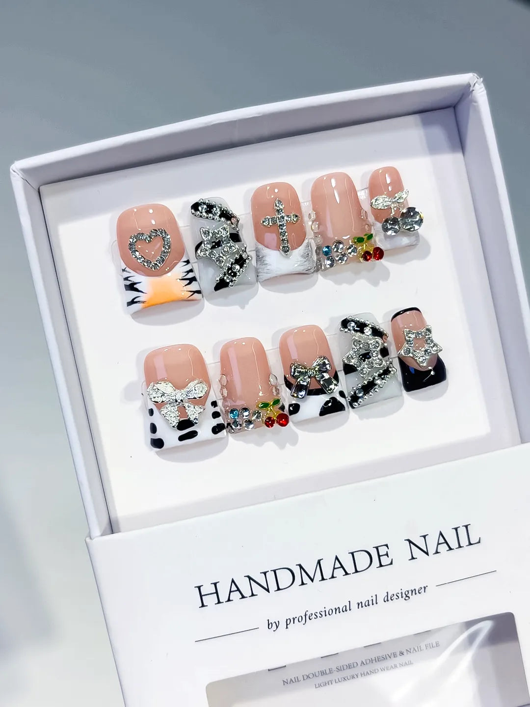 Nude Black White Silver Abstract Bow Heart Cross Cherry Rhinestone press on nails angled view