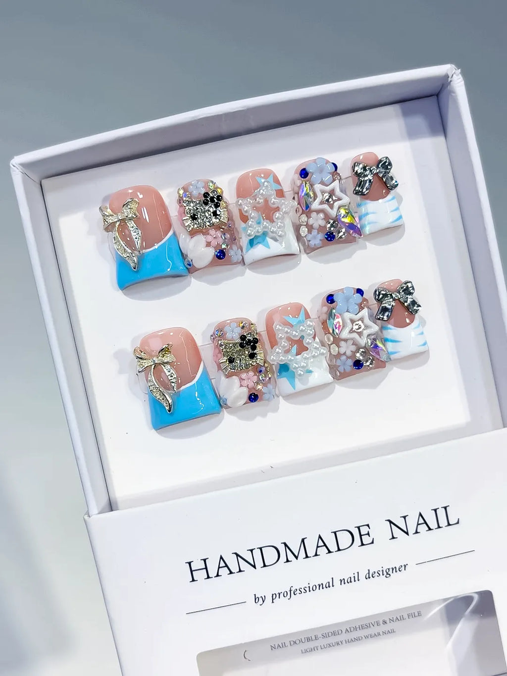 Nude Blue White Silver Abstract Bow Flower Star Rhinestone 3D press on nails angled view