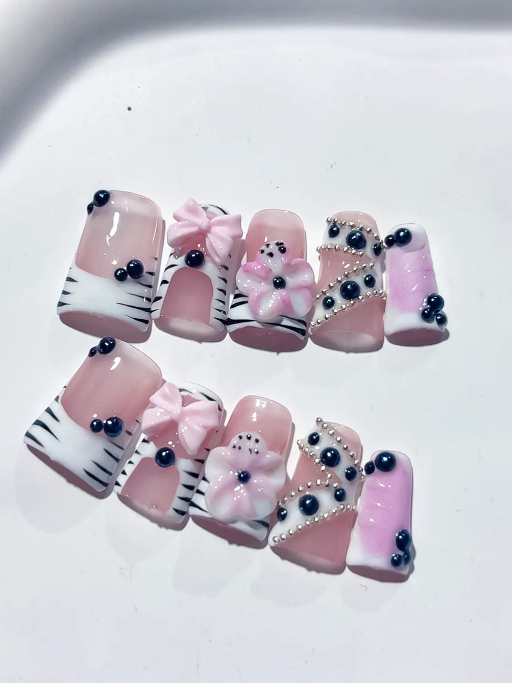 Pink White Black Abstract Bow Flower Pearl 3D press on nails close up
