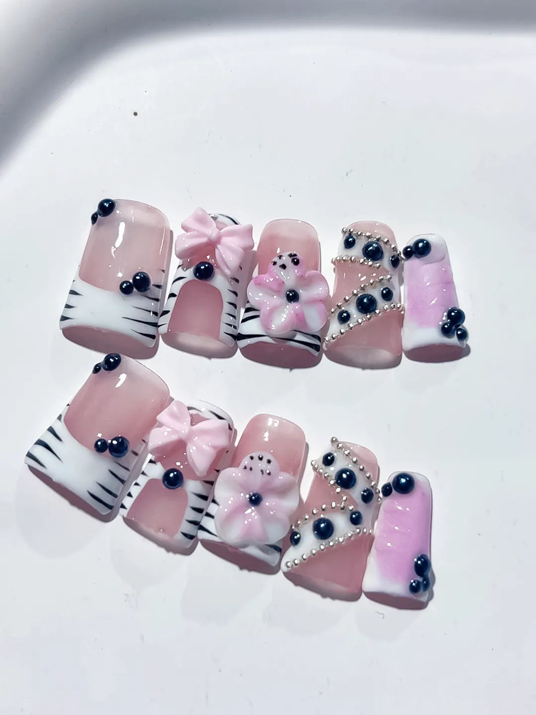 Pink White Black Abstract Bow Flower Pearl 3D press on nails close up