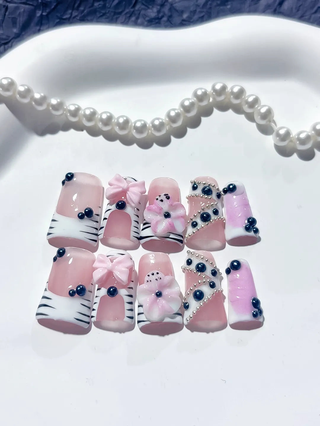 Pink White Black Abstract Bow Flower Pearl 3D press on nails detail view