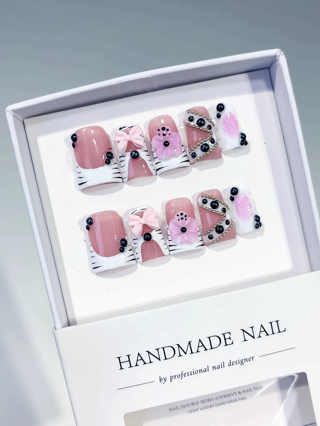 Pink White Black Abstract Bow Flower Pearl 3D press on nails angled view