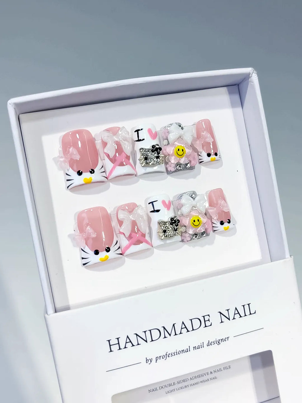 Pink White Black Silver Abstract Bow Smile Text Hello Kitty Rhinestone 3D press on nails angled view