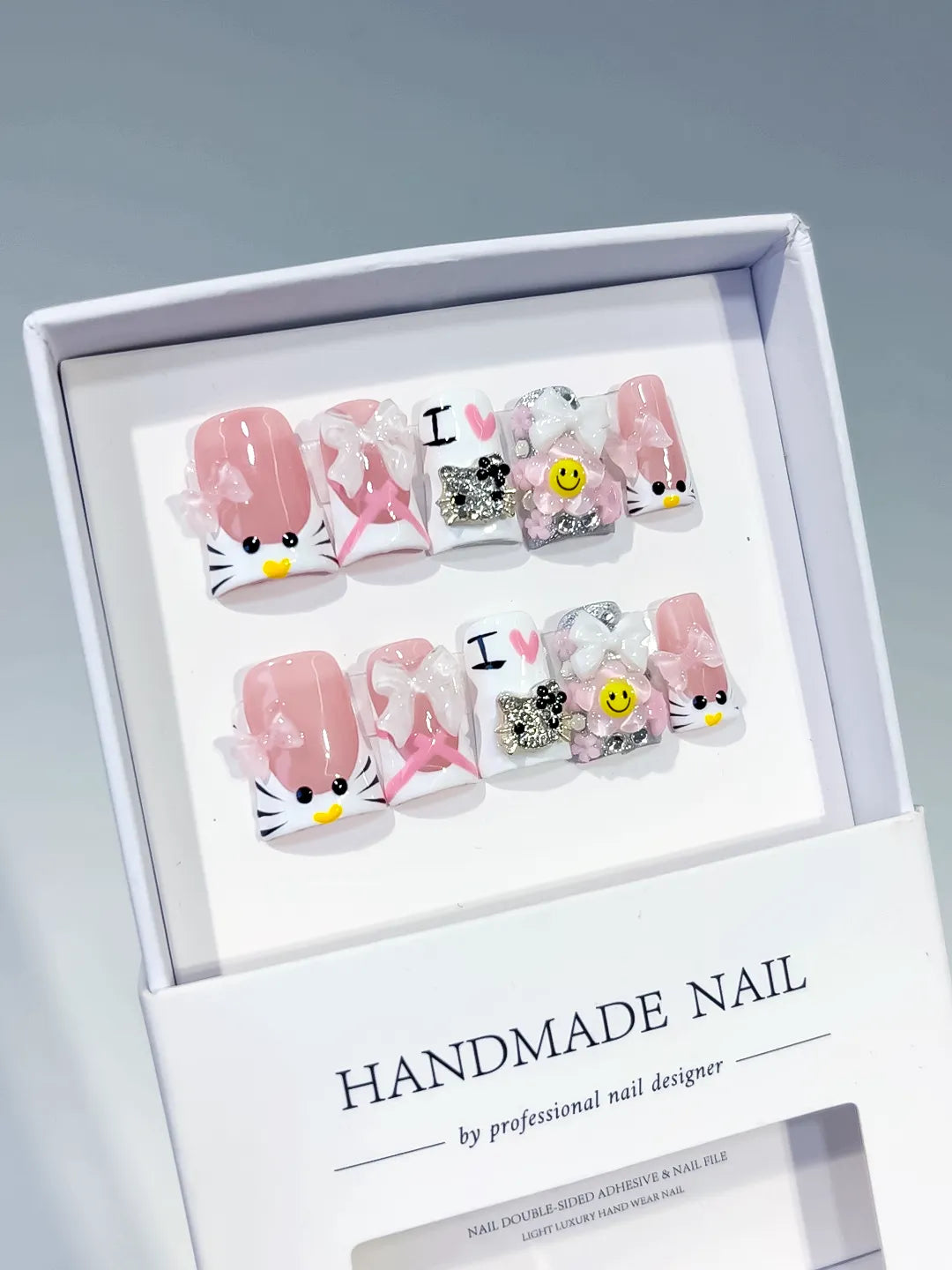 Pink White Black Silver Abstract Bow Smile Text Hello Kitty Rhinestone 3D press on nails angled view