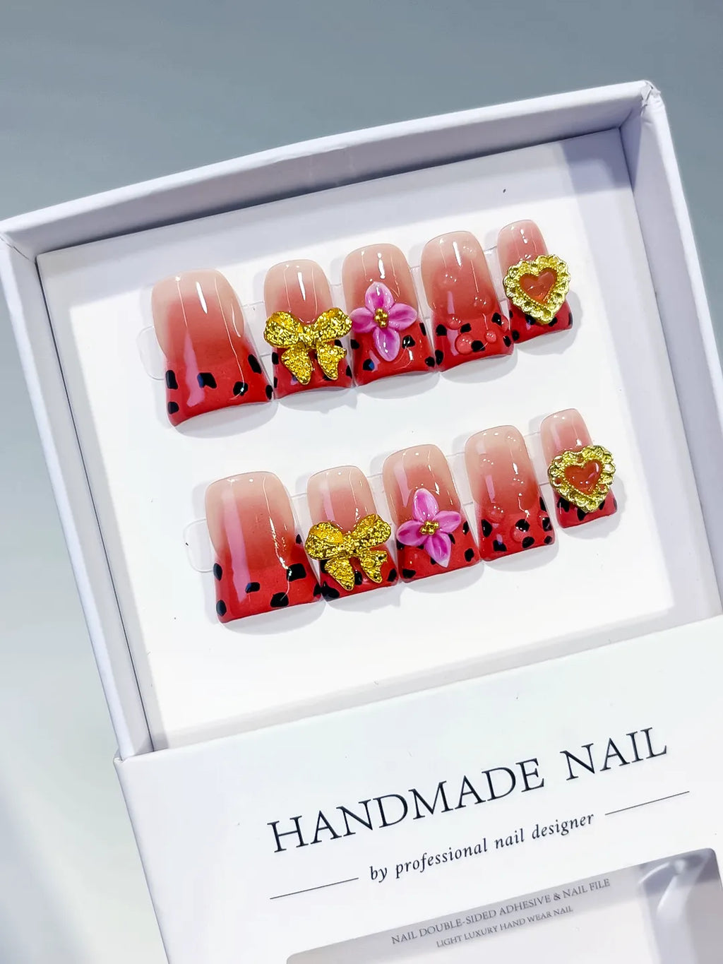 Nude Red Black Gold Abstract Bow Flower Heart press on nails angled view