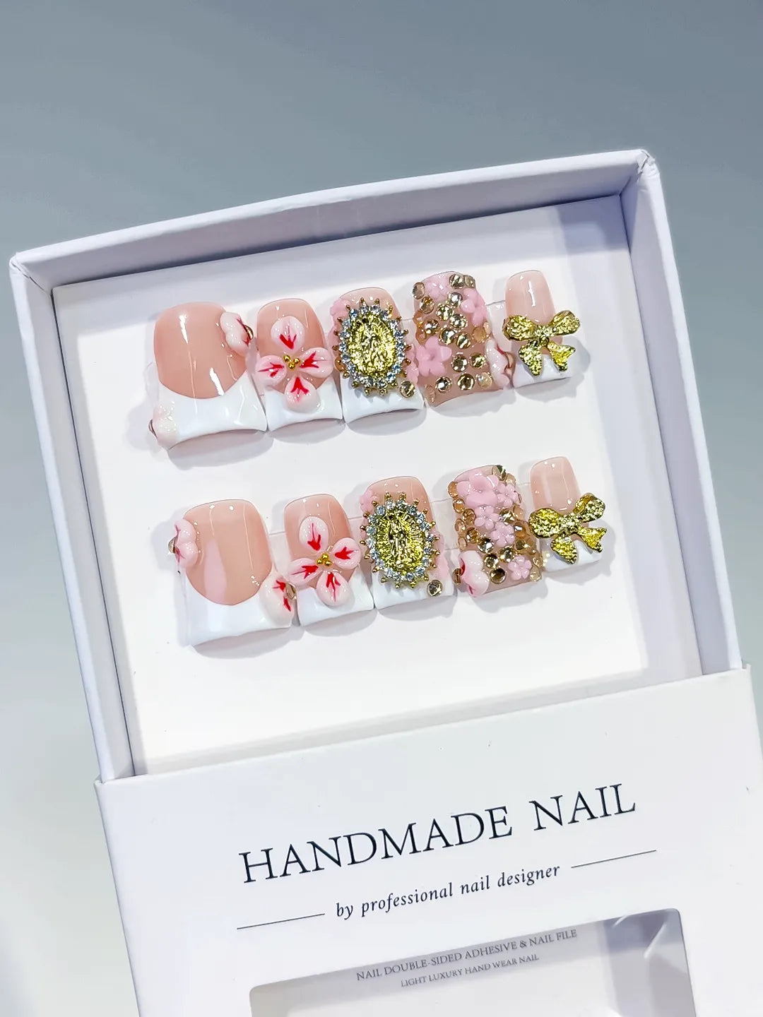 Nude White Pink Gold French tip Flower Bow Rhinestone press on nails angled view
