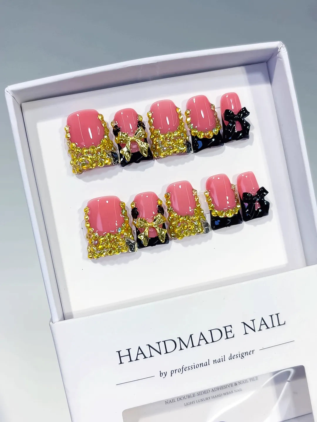 Pink Black Gold French tip Bow Rhinestone press on nails angled view
