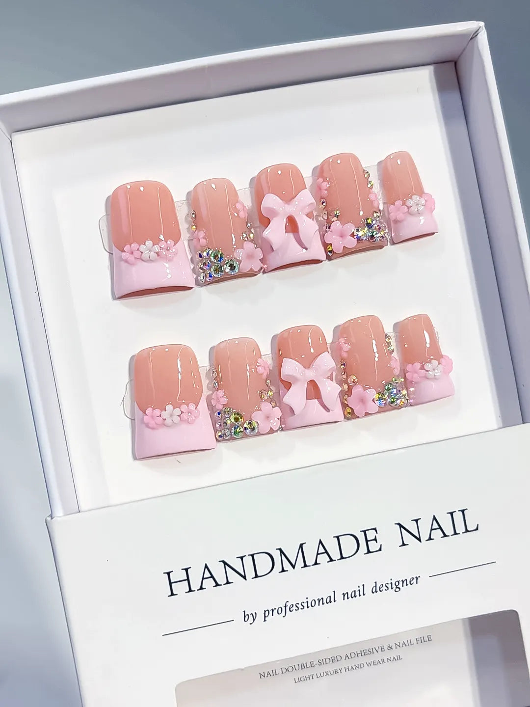 Nude Pink White Gold French tip Flower Bow Rhinestone 3D press on nails angled view