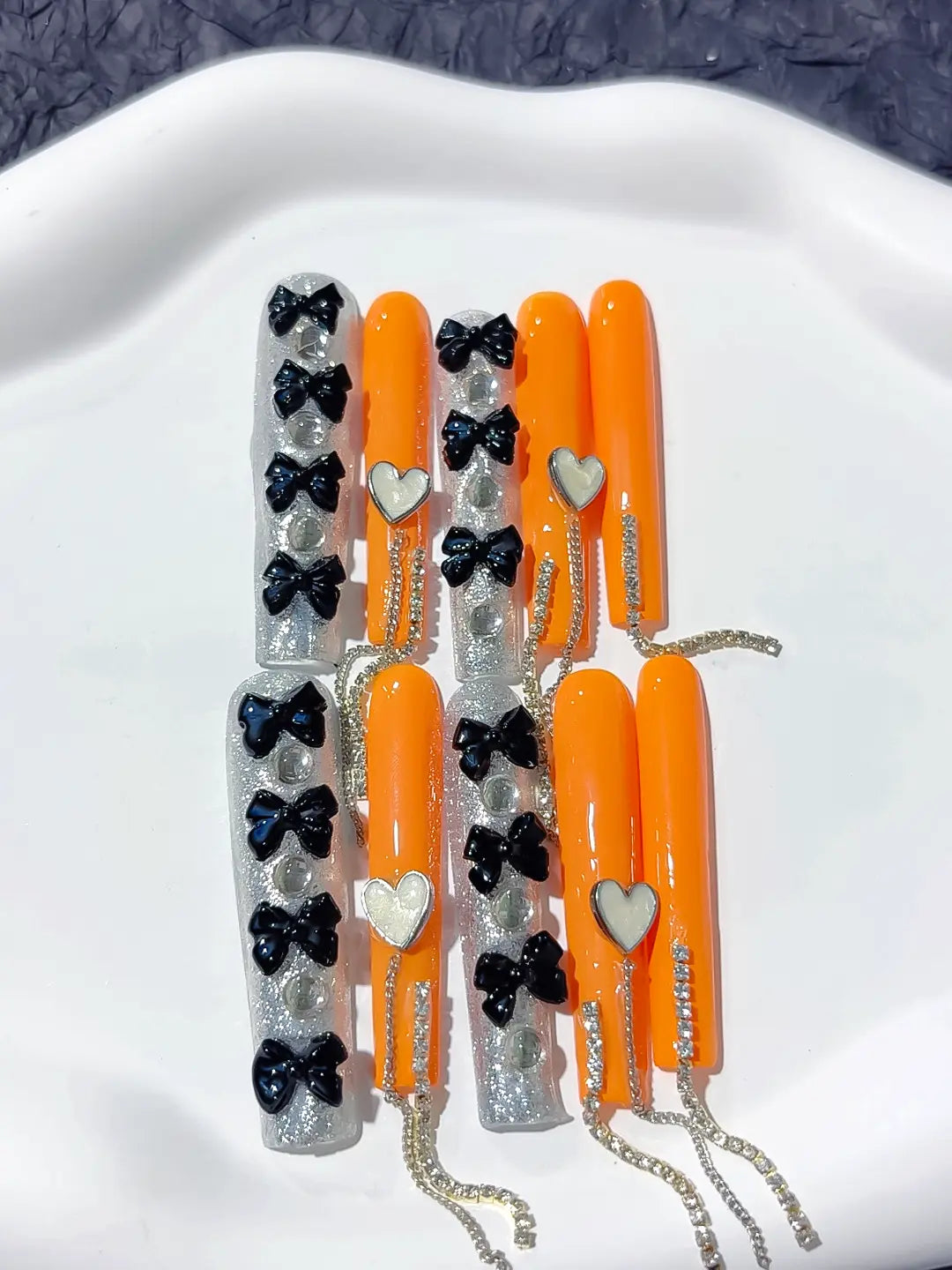 Long square orange handmade press on nails with 3D black bows and dangling rhinestone chains
