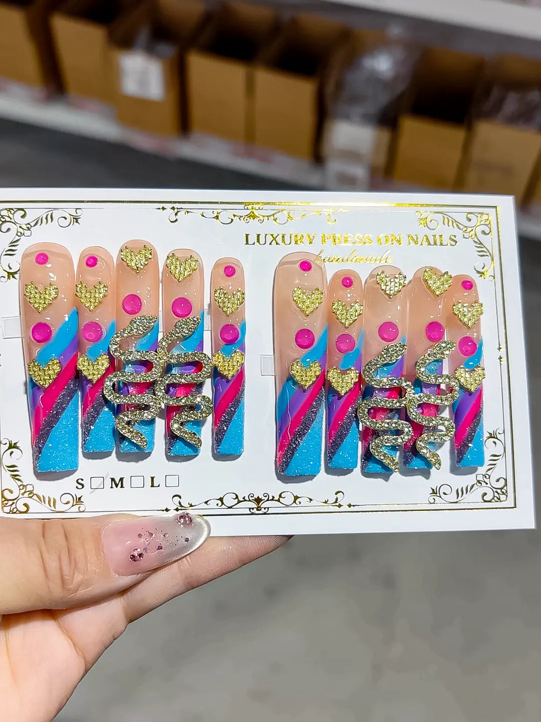 Long square set in blue glitter with pink dots and gold snake charm centerpiece