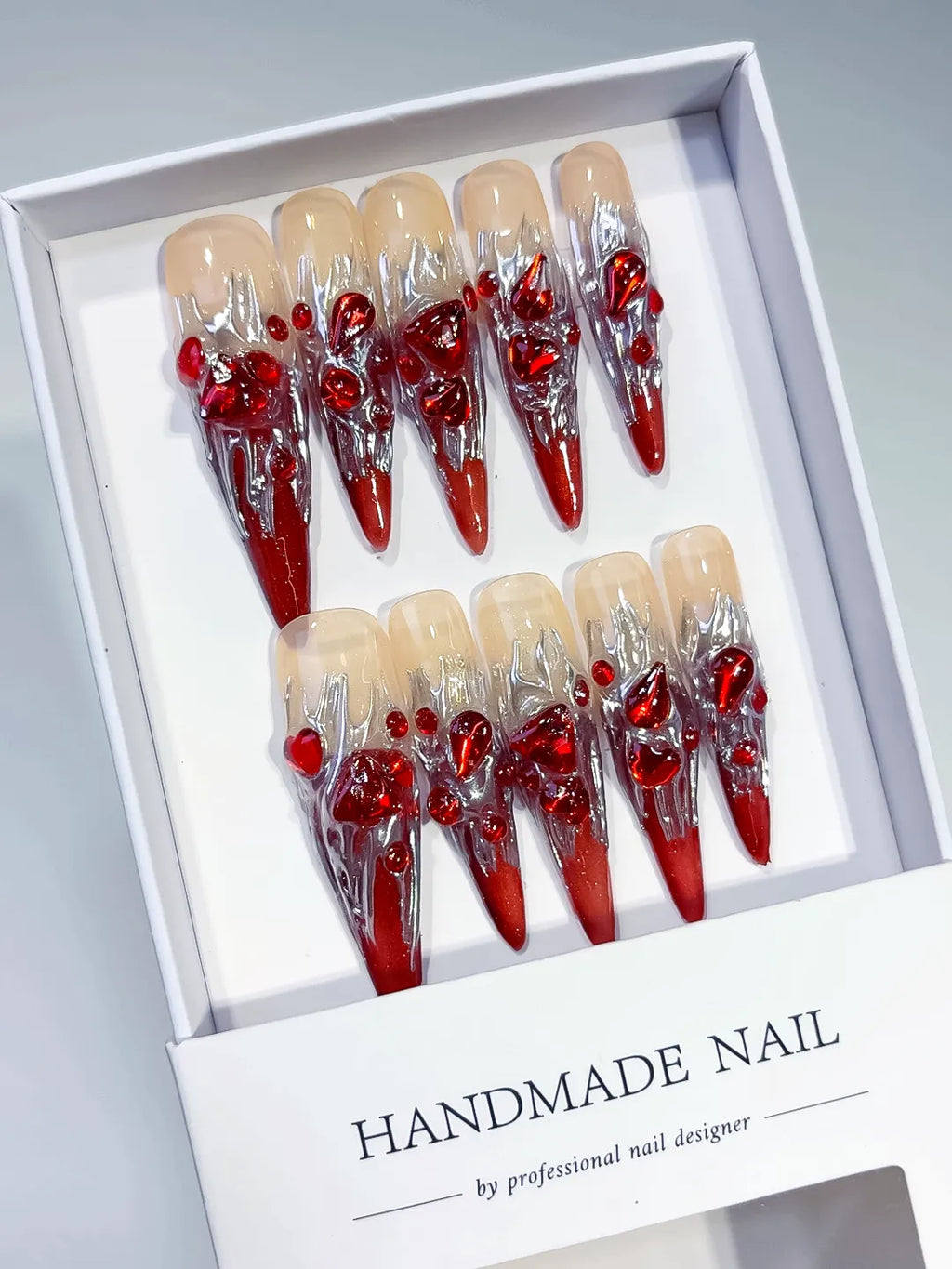 Red White Gold Abstract Bow Metallic Accent press on nails angled view