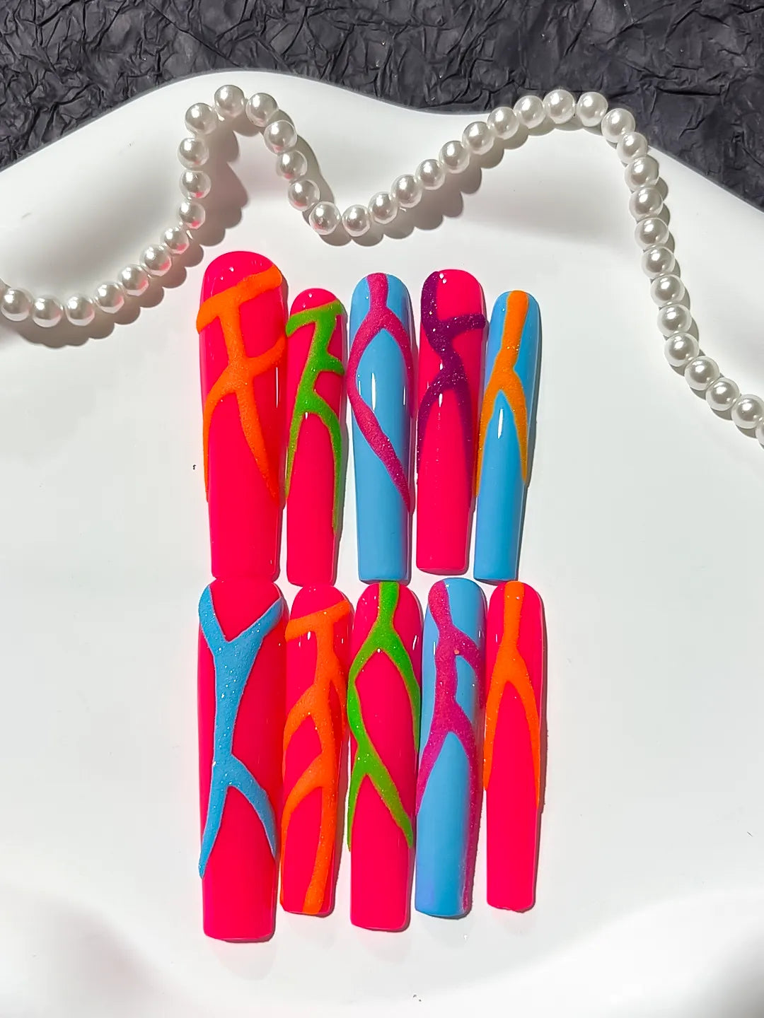 Pink Blue Abstract Swirl press on nails close up