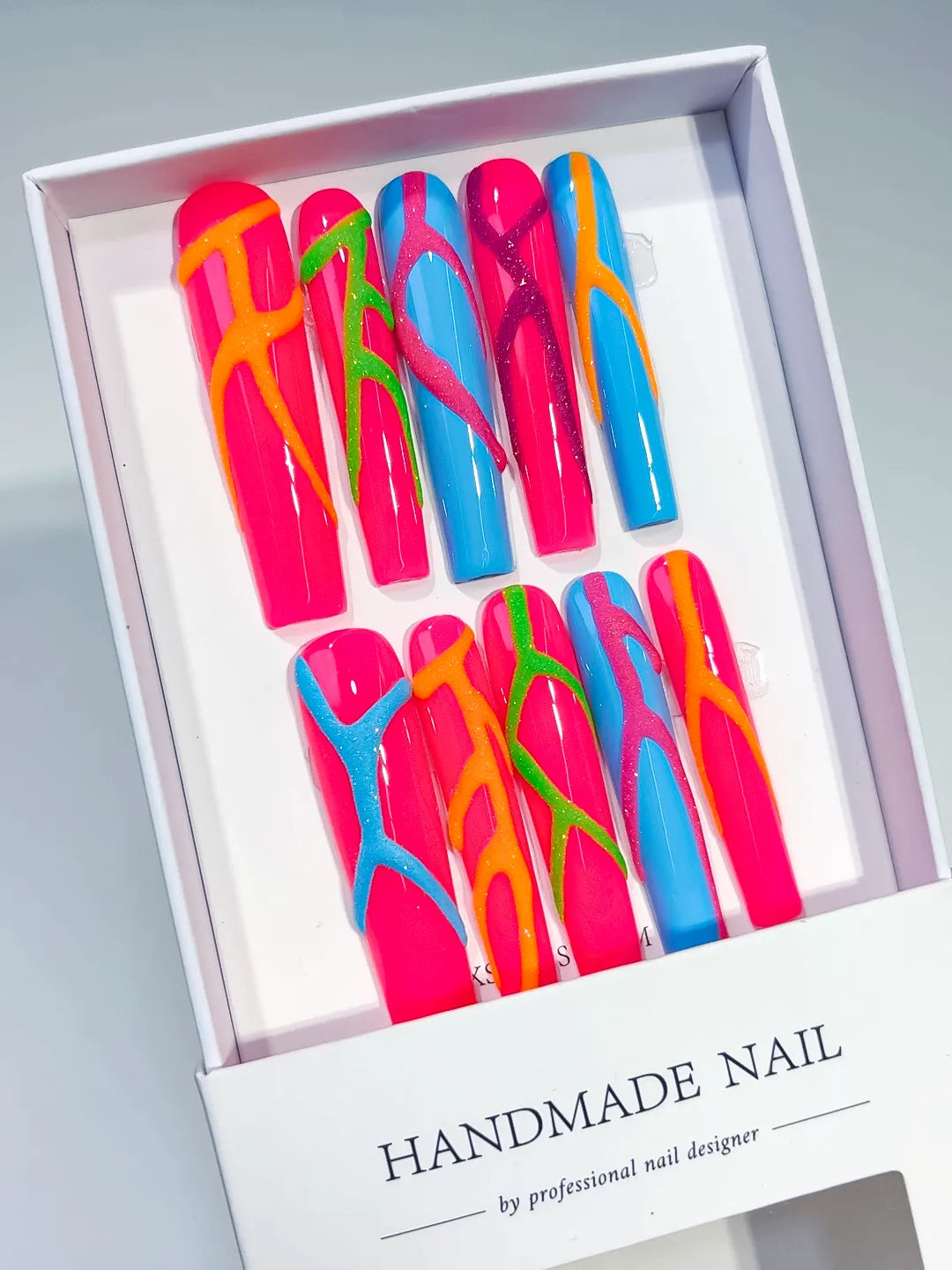 Pink Blue Abstract Swirl press on nails angled view