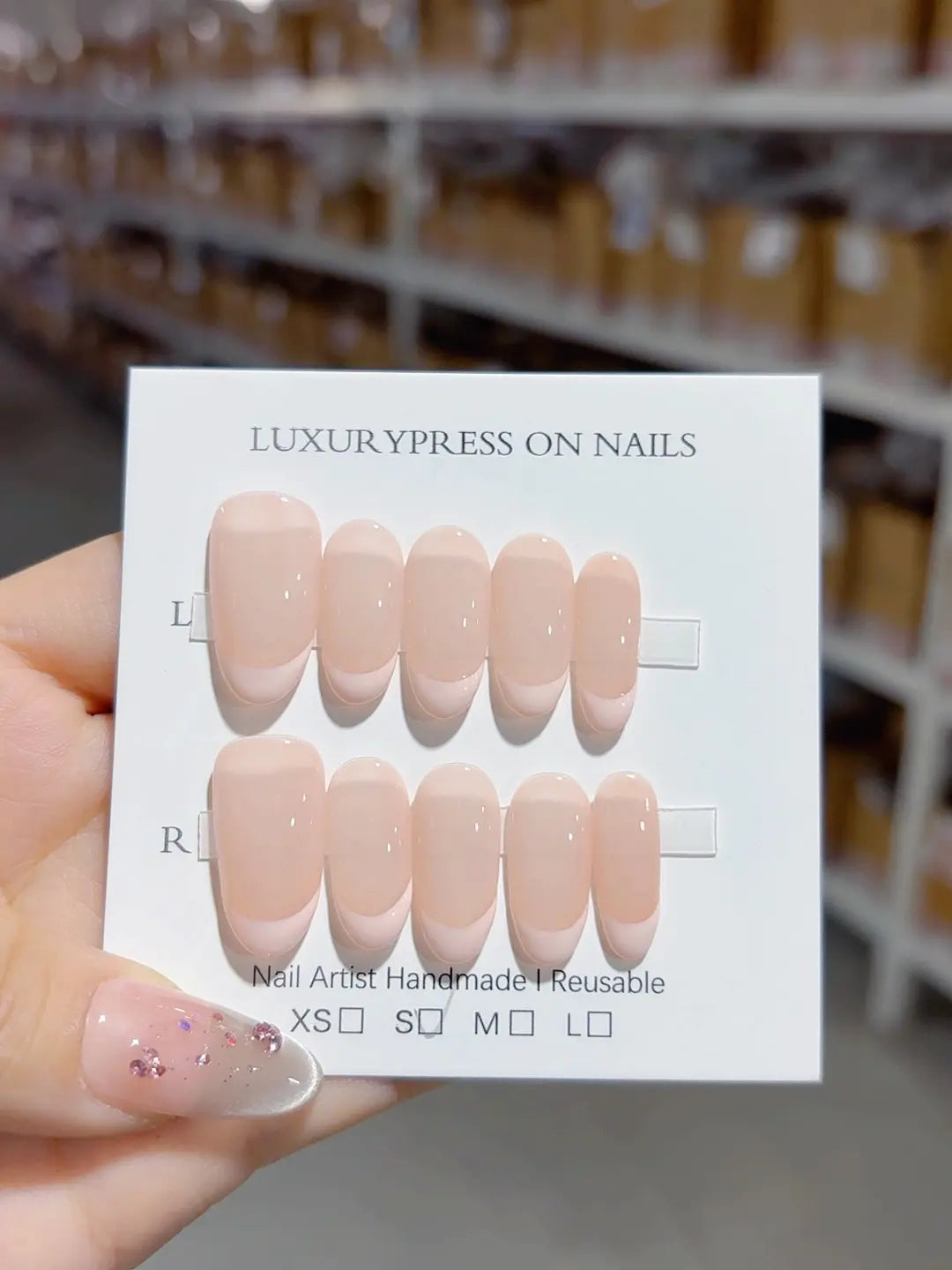Nude pink handmade press on nails angled display in almond shape